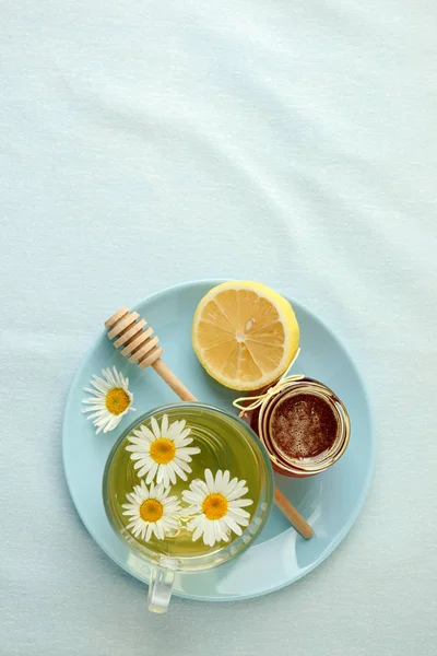 Chamomile flowers and chamomile tea. Chamomile tea in glass teac