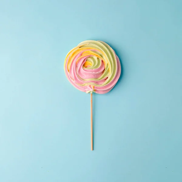 Colorful unicorn rainbow color meringue lollipop candy on pale o