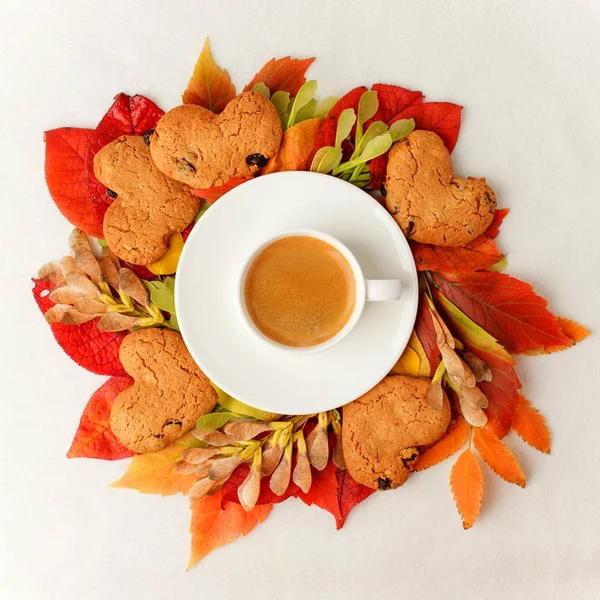 Autumn, fall leaves wreath, hot steaming cup of coffee and cooki