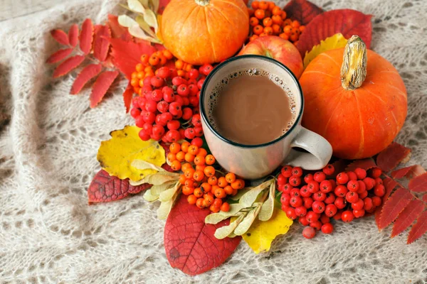 Hot autumn drink, coffee or cocoa, with yellow leaves and decora