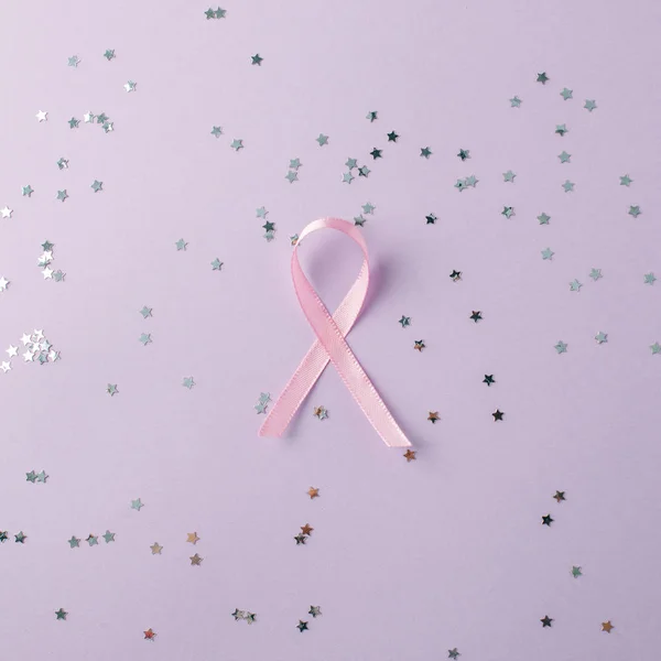 Pink Breast Cancer Ribbon with copy space on pink background. ma
