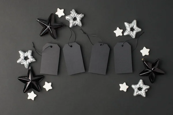 New Year 20202, Christmas Holiday seasonal sale - tags with copy space, gift box and decorations on balck background. Monochrome stylish luxury concept, banner, voucher for shopping