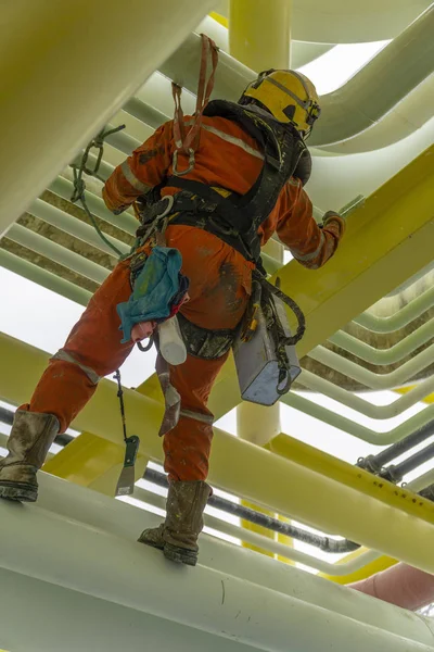 working at height using abseiling technique.