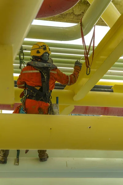 working at height using abseiling technique.