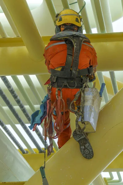 working at height using abseiling technique.