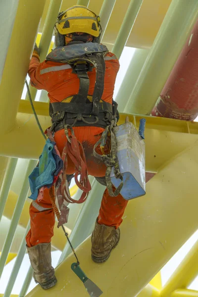 working at height using abseiling technique.