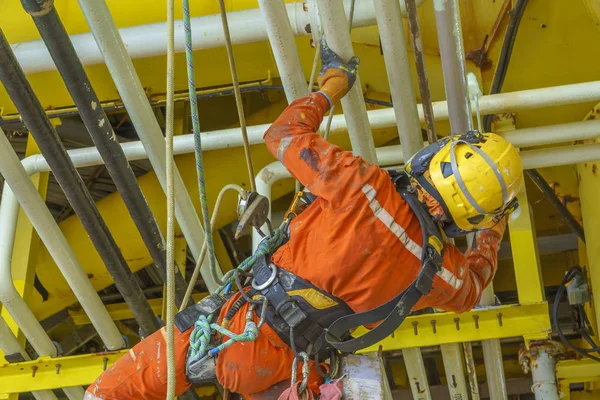 working at height using abseiling technique.