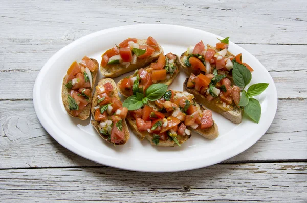 Bruscheta, Antipasti typisch italienisch mit Tomaten, Basilikum und Toas — Stockfoto