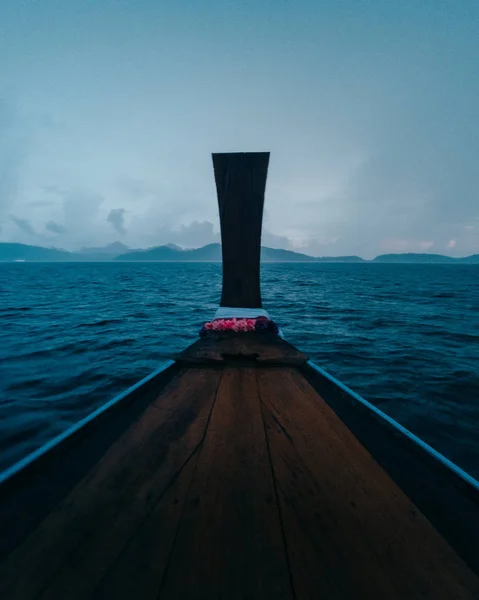 view of boat moving on water with distant rocks