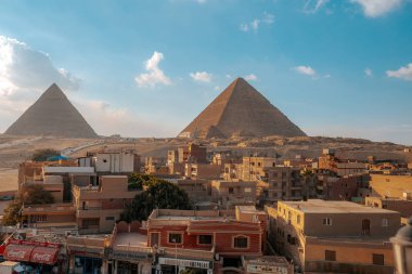view of cairo buildings and pyramids in desert  clipart