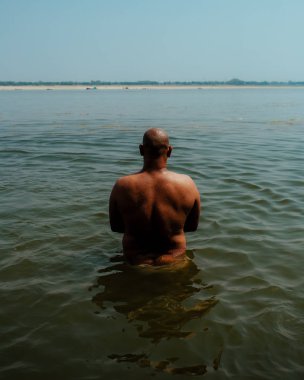 nehir suyunda duran kel adamın arka görünümü