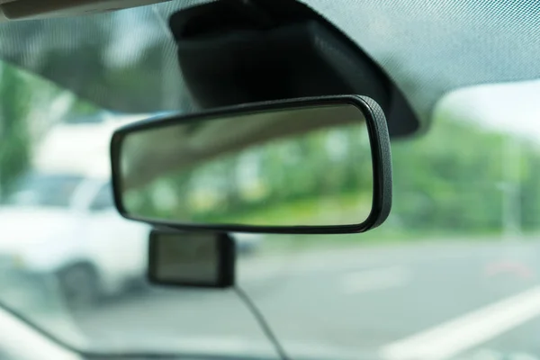 Car rear view mirror. Photograph of the inside of the car.