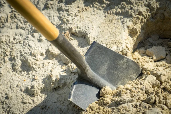 Digging sand with a shovel. place for your text.