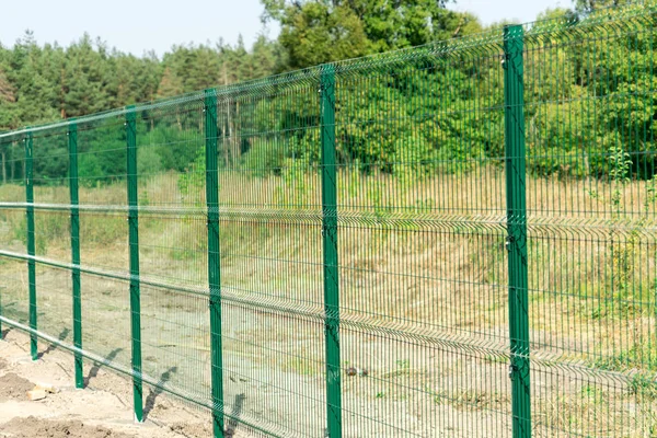 Mesh fence. Metal fence made of welded mesh.