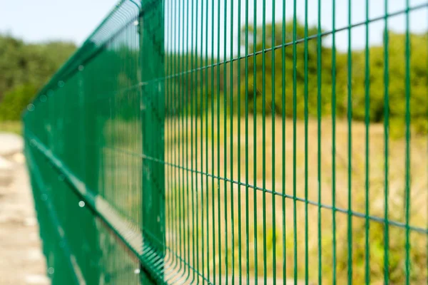 Mesh fence. Metal fence made of welded mesh.