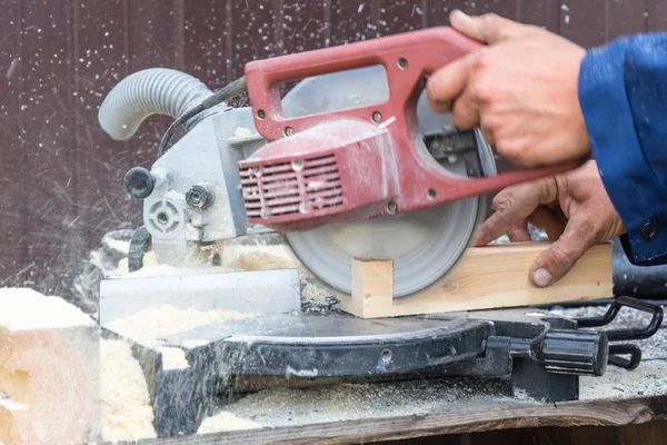 Man sawing wood with a saw. Place for your text..