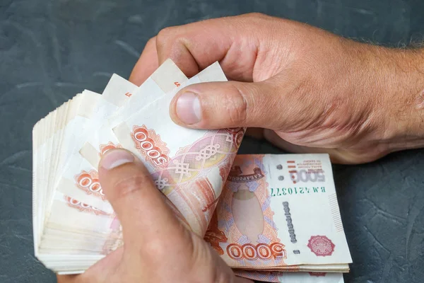 Bir adam bir banknot 5000 ruble bulur. Metniniz için yer