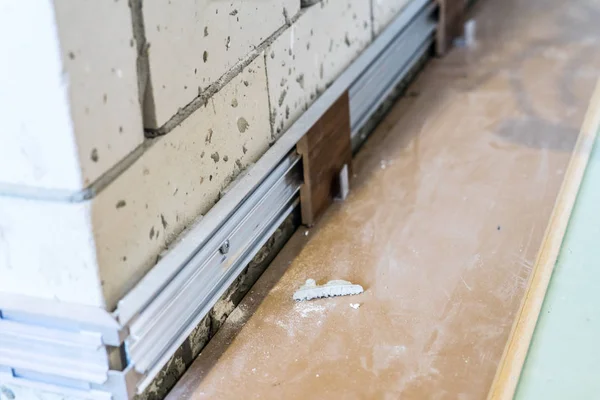 installation of hidden skirting Board at the initial stage of finishing works. Home repair.