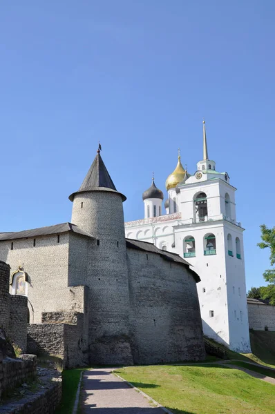 View of the Troitskaya Hourly Tower of Pskov Krom and the bell tower of Holy Trinity Cathedral from the outside of the fortress on a summer afternoon, Russia Royalty Free Stock Photos