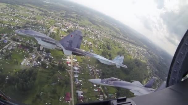 Aircrafts are flying in slow motion on military field. Flght of jet is aerobatic — Stockvideo