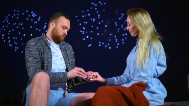 Happy man proposes wedding woman with fireworks in sky and puts ring on finger. — Stock Video