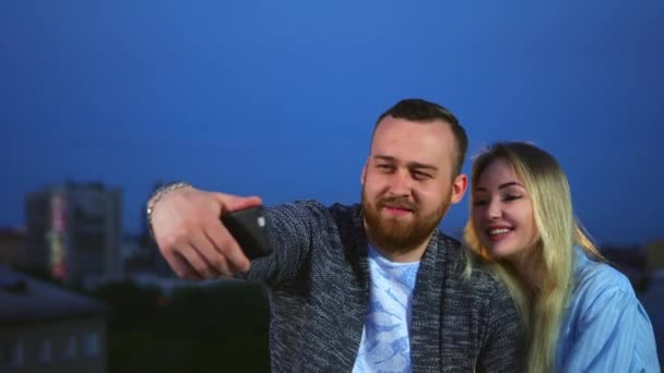 Älskade par på dejt gör selfie på telefon med leende ansikte i natten stad 4K. — Stockvideo