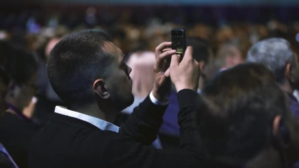 Visor fotografiando el seminario de audiencia telefónica. Auditorio hombres de negocios tomar una foto. — Vídeos de Stock