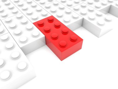 Beyazlar arasında kırmızı oyuncak tuğla