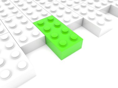 Beyazlar arasında yeşil oyuncak tuğla