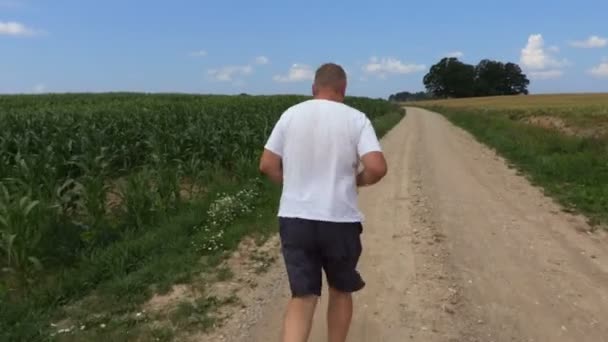 Camera Follow Runner Rural Road — Stock Video