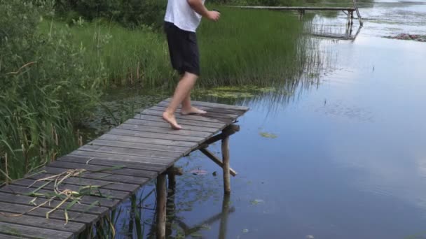 Man Relaxing Pond Footboard — Stock Video