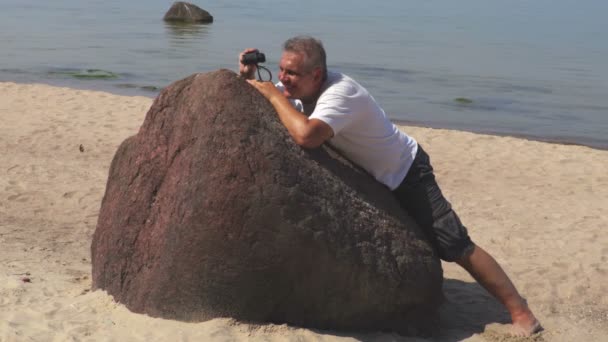 Homem Esconde Atrás Pedra Usando Binóculos — Vídeo de Stock