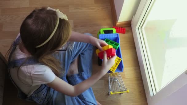 Girl Loading Colorful Toy Bricks Toy Car — Stock Video