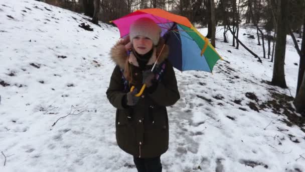 Girl Colorful Umbrella Wet Snow Covered Path — Stock Video