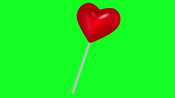 在绿色屏幕上以红色移动棒棒糖 — 图库视频影像