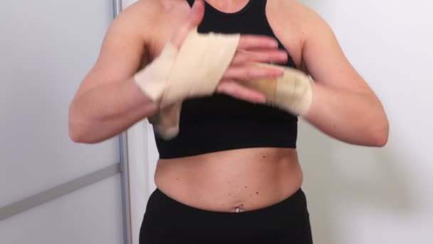 Woman Wrapping Hands Flexible Tape Boxing Workout — Stock Video