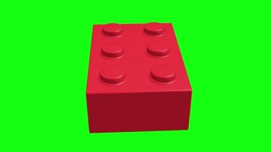Yeşil ekranda dönen kırmızı oyuncak tuğla