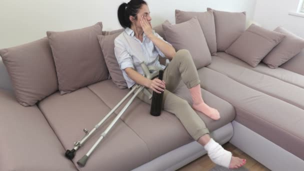 Crying Stressful Woman Crutches Bottle Alcohol Sofa — Stock Video