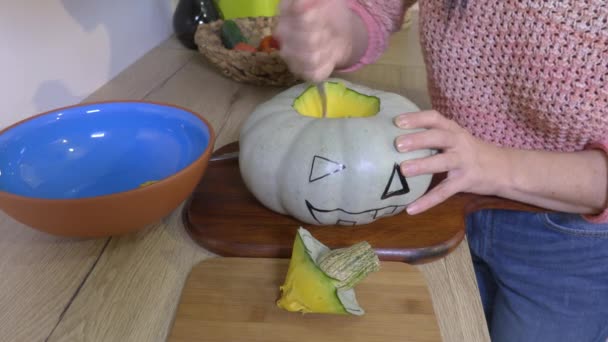 Kobieta Łyżką Rzeźbienie Halloween Dyni — Wideo stockowe