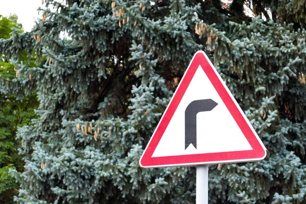Road signs, road sign dangerous turn to the right on the background of trees, traffic rules, driving