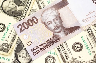 Bir gri, Amerikan bir dolar banknotları ile iki bin Endonezya rupiah banka notu makro yakın