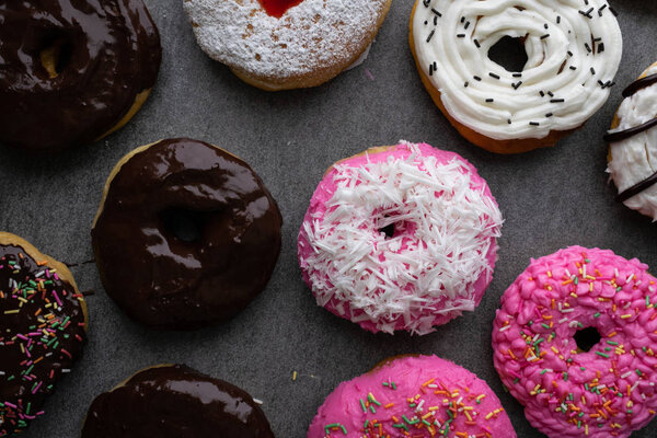 Donut with chocolate glazed and strawberry glazed on concrete ta