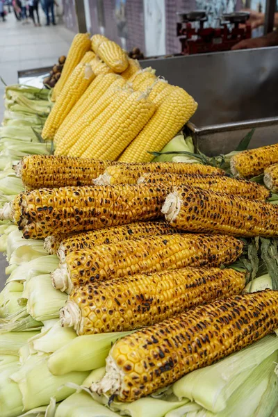 Delicious burnt fire grilled sweet yellow corn with salt flake on cob pile as street food, Istanbul, Turkey