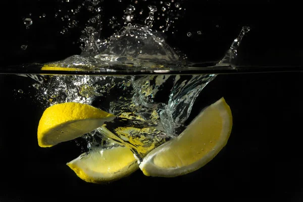 Lemon Black Water Splash Stock Photo