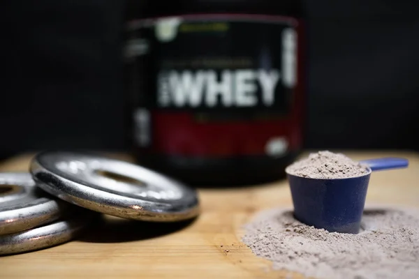 whey protein with protein powder and shaker and dumbells
