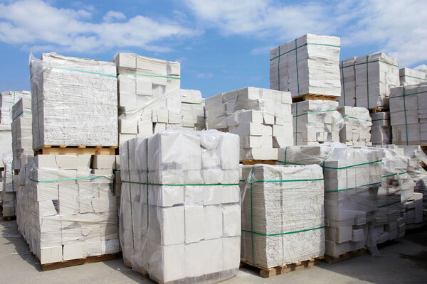Defective aerated concrete blocks on pallets stored at warehouse