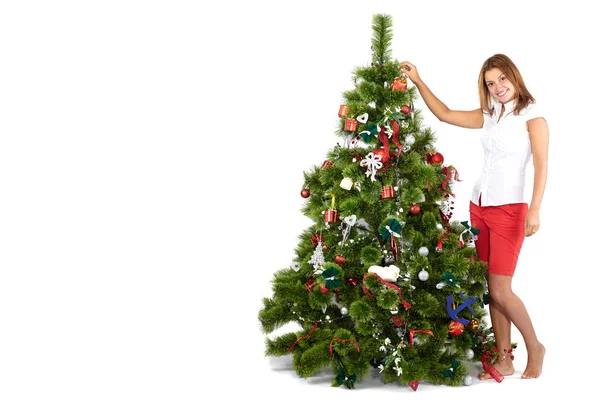 Beautiful smiling woman in red, decorating christmas tree, isolated on white Royalty Free Stock Photos