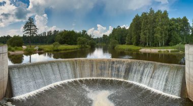 Waterfall at hydroelectric power plant dam (Semicircular spillway) near Yaropolets village. Built in 1919 on the Lama River. Volokolamsky district, Moscow region, Russia clipart