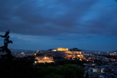 Atina manzaralı Philopapou Tepesi'nden mavi saatte Attica, Yunanistan Herodium, Akropol ve Parthenon gördüm