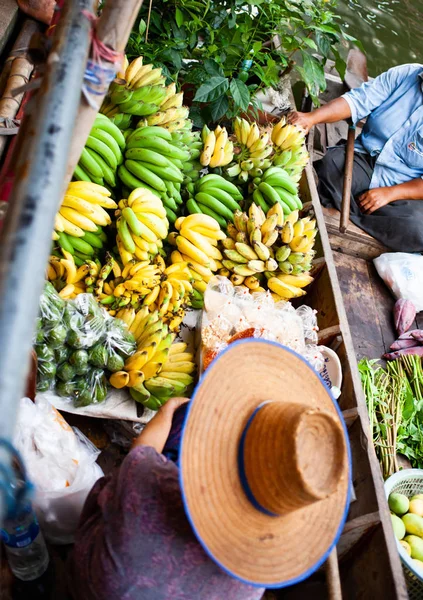 floating market - top view of boat full of fresh fruits on sale